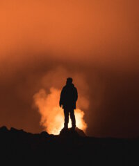 Exploring Visual Narratives - Man standing on a mountain at sunset