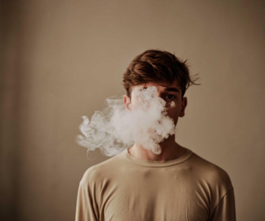 A Young Adult With Abstract Smoke On His Face